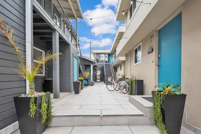 a walkway between two buildings with bikes parked on it at Tower 9 #4 in Oceanside