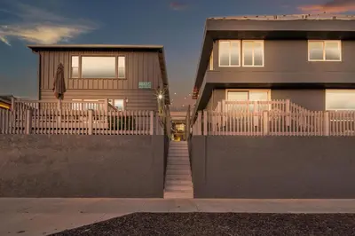 a house with a fence in front of it at Tower 9 #4 in Oceanside