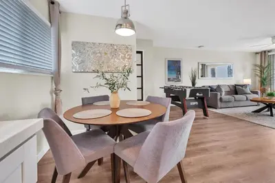 a dining room and living room with a table and chairs at Tower 9 #5 in Oceanside