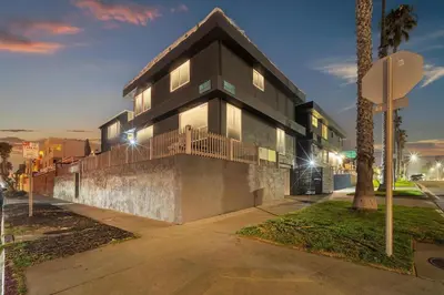 a black building with a balcony on a street at Tower 9 #5 in Oceanside