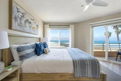 a bedroom with a bed with a view of the ocean at San Miguel #8 in Oceanside