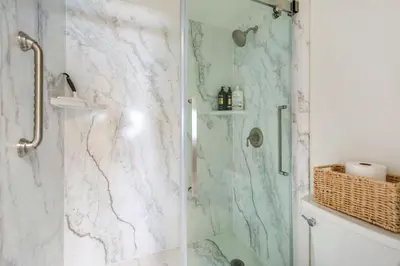 a bathroom with a marble shower with a glass door at San Miguel #8 in Oceanside