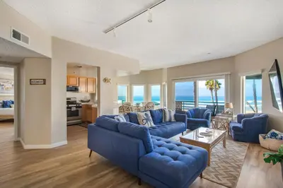 a living room with blue couches and the ocean at San Miguel #8 in Oceanside