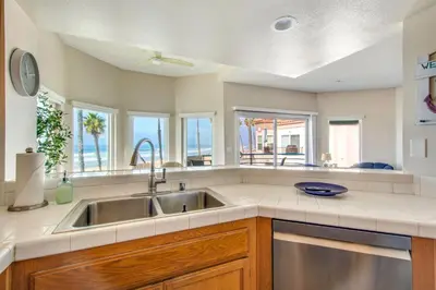 a kitchen with a sink and some windows at San Miguel #8 in Oceanside