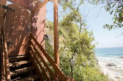 a stairway leading up to a house with the beach at OCEAN FRONT Beach HOUSE! Private Stairs to SAND! in Laguna Beach