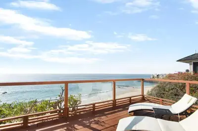 a balcony with a view of the beach at OCEAN FRONT Beach HOUSE! Private Stairs to SAND! in Laguna Beach