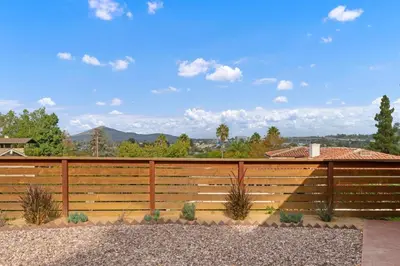 a wooden fence with a view of the mountains at Designer 4 BR La Mesa Home w/ Yard and BBQ in La Mesa