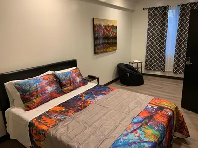 a bedroom with a bed and a painting on the wall at Hotel Gigi in San Diego