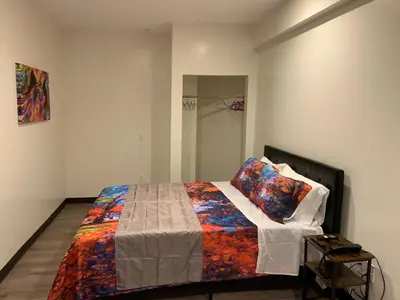 a bedroom with a bed with a colorful blanket at Hotel Gigi in San Diego