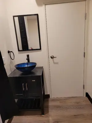 a bathroom with a blue bowl sink and a mirror at Hotel Gigi in San Diego