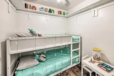 a bunk bed in a room with a table at Garden, Gazebo and Fire Pit Fallbrook Home! in Fallbrook
