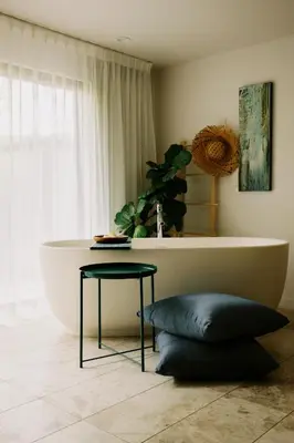 a bathroom with a tub and a table and a stool at Twelve Senses Retreat in Encinitas
