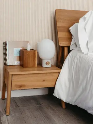 a bed with a night stand with a lamp on it at Twelve Senses Retreat in Encinitas