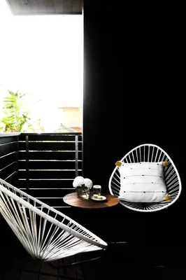 a white chair and a table on a balcony at Twelve Senses Retreat in Encinitas