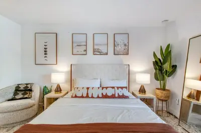 a bedroom with a bed and a chair at Ritz Pointe Paradise! in Dana Point