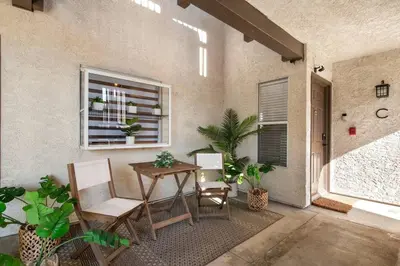a patio with a table and chairs and a window at Ritz Pointe Paradise! in Dana Point