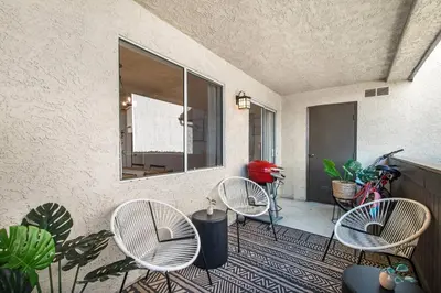 a patio with three chairs and a mirror at Ritz Pointe Paradise! in Dana Point