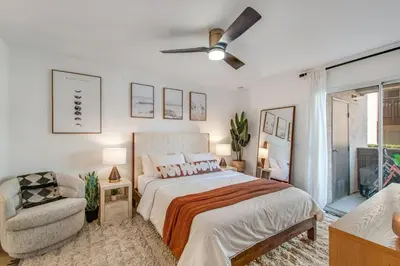 a bedroom with a bed and a chair at Ritz Pointe Paradise! in Dana Point