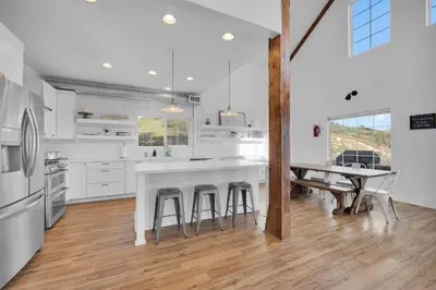 a white kitchen with a table and stools at Ask about the 100 Dollar Taco Caterer for 10 and Free Wine Tickets in Temecula