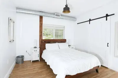 a white bedroom with a large bed and a window at Ask about the 100 Dollar Taco Caterer for 10 and Free Wine Tickets in Temecula