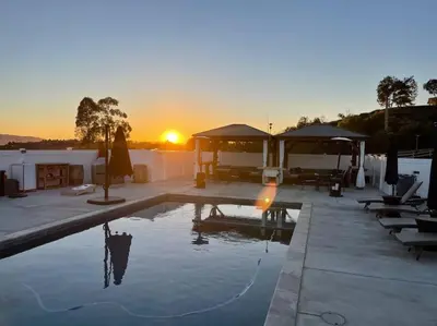 a swimming pool with the sunset in the background at Ask about the 100 Dollar Taco Caterer for 10 and Free Wine Tickets in Temecula