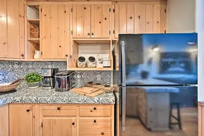 a kitchen with a refrigerator and wooden cabinets at Inviting Julian Home with Scenic View and Hot Tub in Julian