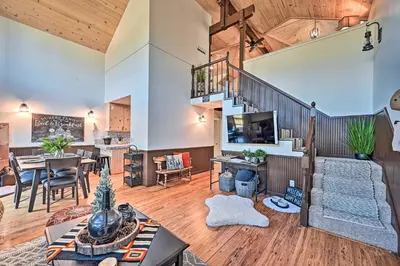 a living room with a staircase and a dining room at Inviting Julian Home with Scenic View and Hot Tub in Julian