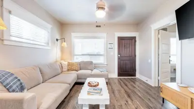 a living room with a couch and a table at Sea Sight by AvantStay Walk to Newport Beach in Newport Beach