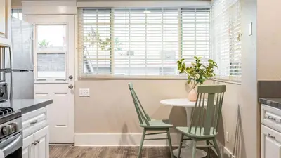 a kitchen with a table and chairs and a window at Sea Sight by AvantStay Walk to Newport Beach in Newport Beach