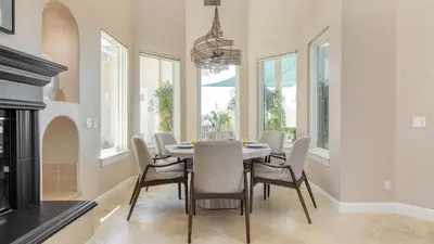 a dining room with a table and chairs and a chandelier at Modern Temecula Mansion w Pool Hot Tub Guest House Valley Views Camila by AvantStay in Temecula