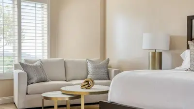 a bedroom with a bed and a couch and a table at Modern Temecula Mansion w Pool Hot Tub Guest House Valley Views Camila by AvantStay in Temecula