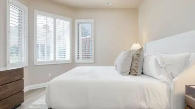a white bedroom with a large bed with white pillows at Modern Temecula Mansion w Pool Hot Tub Guest House Valley Views Camila by AvantStay in Temecula