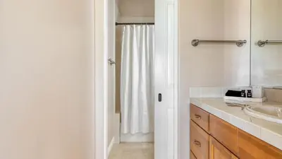 a white bathroom with a sink and a shower at Modern Temecula Mansion w Pool Hot Tub Guest House Valley Views Camila by AvantStay in Temecula