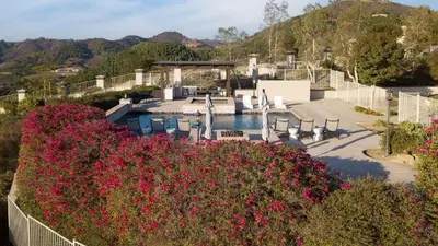 a garden with pink flowers and a swimming pool at Modern Temecula Mansion w Pool Hot Tub Guest House Valley Views Camila by AvantStay in Temecula
