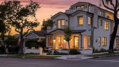 a white house with a sunset in the background at Sea Crown by AvantStay 5mins from the Beach w Multiple Terraces PermitSLP13639 in Newport Beach