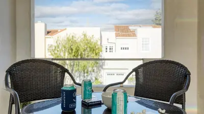 a table with two chairs and a table with food on it at Sea Crown by AvantStay 5mins from the Beach w Multiple Terraces PermitSLP13639 in Newport Beach