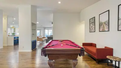 a room with a pool table and a red chair at 5-Acre Hilltop Estate w Resort Pool Game Room Le Grand Bleu by AvantStay in Temecula