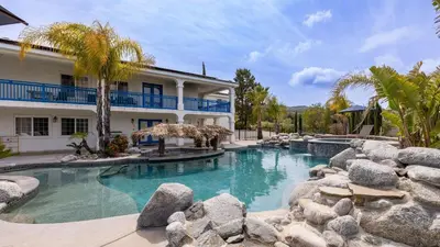 a swimming pool in front of a house at 5-Acre Hilltop Estate w Resort Pool Game Room Le Grand Bleu by AvantStay in Temecula