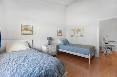 a bedroom with two beds and a desk in it at Carlsbad Hideway Pool Spa in Carlsbad