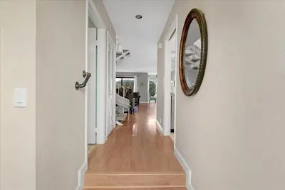 a hallway of a home with a mirror on the wall at Carlsbad Hideway Pool Spa in Carlsbad