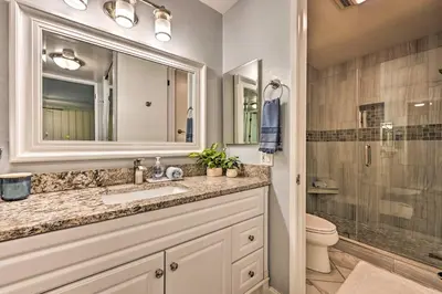 a bathroom with a sink and a toilet and a shower at Deja Blue Oceanside Condo on Beach with Pools! in Oceanside
