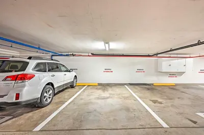 a white car parked in a parking lot at Deja Blue Oceanside Condo on Beach with Pools! in Oceanside