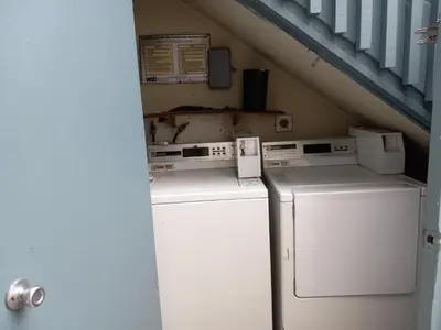 a laundry room with two machines and a staircase at Master SUITE STEPS TO BAY & BEACH in San Diego