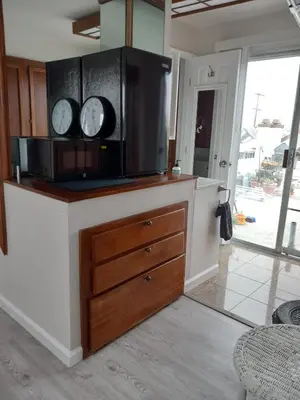 a kitchen with two clocks on top of a counter at Master SUITE STEPS TO BAY & BEACH in San Diego
