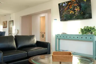 a living room with a couch and a glass table at Aviation Landing in Fallbrook