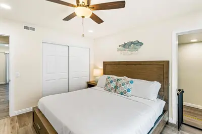 a bedroom with a bed and a ceiling fan at 4912 Seashore A Lower in Newport Beach