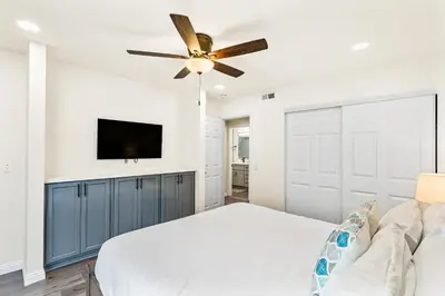 a bedroom with a bed and a ceiling fan at 4912 Seashore A Lower in Newport Beach