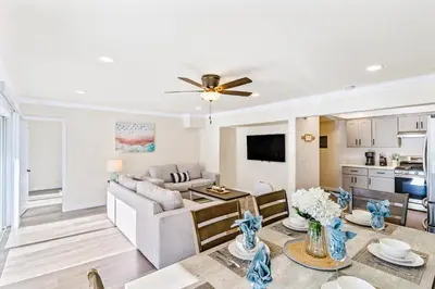 a living room with a couch and a table at 4912 Seashore A Lower in Newport Beach