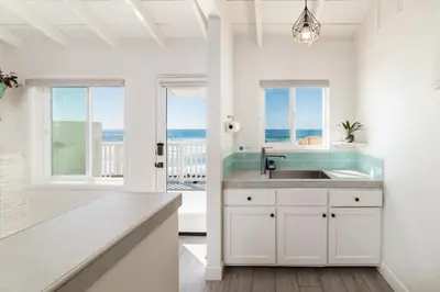 a kitchen with a sink and a view of the ocean at Pacific Villas in Oceanside