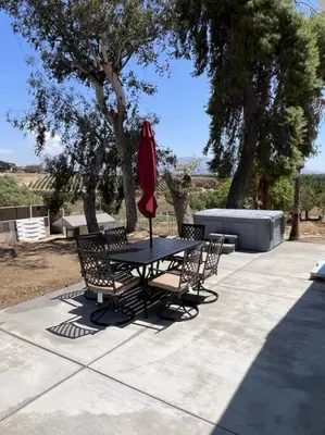 a table and chairs with a red umbrella at Temecula Rejuvenation in Temecula